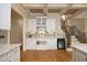 Bright kitchen with white cabinetry, under cabinet lighting, wine cooler and stylish backsplash at 12417 Richmond Run Dr, Raleigh, NC 27614