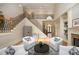 Bright living area with fireplace, an iron-detailed staircase, and comfortable seating at 12417 Richmond Run Dr, Raleigh, NC 27614
