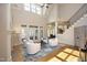 Spacious living room with high ceilings, a fireplace, and French doors leading to the outdoors at 12417 Richmond Run Dr, Raleigh, NC 27614