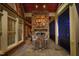 Covered porch with outdoor cooking area featuring a stainless steel grill and bar seating at 12417 Richmond Run Dr, Raleigh, NC 27614