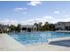 A pristine outdoor pool with marked lanes, surrounded by lush greenery and a clubhouse at 12417 Richmond Run Dr, Raleigh, NC 27614