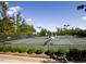 Outdoor tennis courts surrounded by mature trees and well-maintained landscaping at 12417 Richmond Run Dr, Raleigh, NC 27614