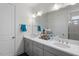 Bathroom featuring double sinks, gray cabinets, a large mirror and a separate walk-in shower at 133 Alumroot Road Rd, Holly Springs, NC 27540