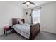 This bedroom features a dark wood bed frame, neutral walls, and a ceiling fan for added comfort at 133 Alumroot Road Rd, Holly Springs, NC 27540
