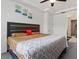 Cozy bedroom featuring a king-sized bed and carpeted floor, illuminated by recessed lighting at 133 Alumroot Road Rd, Holly Springs, NC 27540
