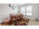 Bright dining room with a wood table, six chairs, and large windows offering lots of natural light at 133 Alumroot Road Rd, Holly Springs, NC 27540