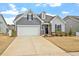 Beautiful two-story home boasts a two-car garage, brick accents, and a well-manicured lawn at 133 Alumroot Road Rd, Holly Springs, NC 27540