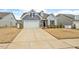 Charming home with a two-car garage, brick accents, and neatly maintained landscaping at 133 Alumroot Road Rd, Holly Springs, NC 27540