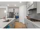 Modern kitchen featuring stainless steel appliances, gray cabinets, and a stylish backsplash at 133 Alumroot Road Rd, Holly Springs, NC 27540