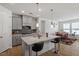 Well-lit kitchen with a center island, stainless steel appliances, and an open layout at 133 Alumroot Road Rd, Holly Springs, NC 27540
