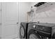 Modern laundry room featuring a washer and dryer set and ample space at 133 Alumroot Road Rd, Holly Springs, NC 27540
