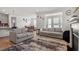 Bright living room featuring modern furnishings, hardwood floors, and an open floor plan at 133 Alumroot Road Rd, Holly Springs, NC 27540