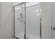 Modern bathroom with a sleek glass-enclosed shower showcasing white tile at 133 Alumroot Road Rd, Holly Springs, NC 27540