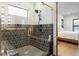 Modern shower featuring black and white tiling, a glass enclosure, and a convenient built-in bench at 1354 Briar Chapel Pkwy, Chapel Hill, NC 27516