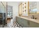 Well-lit bathroom with a double vanity, modern fixtures, and stylish black and white tile floor at 1354 Briar Chapel Pkwy, Chapel Hill, NC 27516