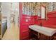 Unique powder room with tiger-themed wallpaper, red paneling, and a decorative vanity at 1354 Briar Chapel Pkwy, Chapel Hill, NC 27516