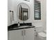 Charming bathroom with a stylish oval mirror, modern fixtures, and black marble counter at 1354 Briar Chapel Pkwy, Chapel Hill, NC 27516