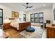 Comfortable bedroom featuring wood floors, ceiling fan, and bright windows with shutter blinds at 1354 Briar Chapel Pkwy, Chapel Hill, NC 27516