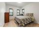 Bright bedroom with floral quilt, wood dresser, and natural light from shuttered windows at 1354 Briar Chapel Pkwy, Chapel Hill, NC 27516