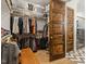 Walk-in closet with custom shelving and storage, leading to an elegant bathroom with tile flooring at 1354 Briar Chapel Pkwy, Chapel Hill, NC 27516