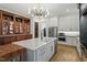 Bright and modern kitchen features a central island, stainless steel appliances and custom cabinetry at 1354 Briar Chapel Pkwy, Chapel Hill, NC 27516