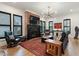 Bright living room with brick fireplace, comfortable seating, and large windows at 1354 Briar Chapel Pkwy, Chapel Hill, NC 27516