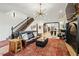 Elegant living room with grand staircase, modern lighting fixture, and opening to the kitchen at 1354 Briar Chapel Pkwy, Chapel Hill, NC 27516