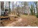 Large backyard with a deck, sheds, and mature trees, perfect for outdoor activities at 136 Dixie Ln, Youngsville, NC 27596