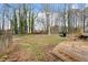 Expansive backyard featuring a wooden deck and mature trees at 136 Dixie Ln, Youngsville, NC 27596