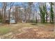 Large backyard featuring two sheds and mature trees at 136 Dixie Ln, Youngsville, NC 27596