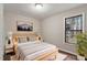 Stylishly staged bedroom with contemporary furnishings, a large window, and wood-look floors at 136 Dixie Ln, Youngsville, NC 27596