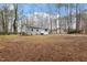 Exterior view of a charming home with a spacious backyard and trees at 136 Dixie Ln, Youngsville, NC 27596