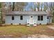 Charming single-story home featuring a light blue exterior and a welcoming white front porch at 136 Dixie Ln, Youngsville, NC 27596