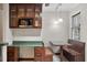 Breakfast nook area with built-in seating, custom cabinetry, a microwave, and natural light at 136 Dixie Ln, Youngsville, NC 27596