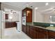 Well-lit kitchen with dark cabinets and green countertops at 136 Dixie Ln, Youngsville, NC 27596
