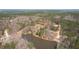 An aerial view showcasing the property's surroundings, highlighting a serene lake and lush greenery at 15 Bourbon St, Fuquay Varina, NC 27526