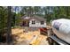 Construction site displaying new home with brick foundation, heavy equipment, and building materials at 15 Bourbon St, Fuquay Varina, NC 27526