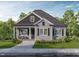 Charming single-story home boasts gray siding, black shutters, inviting front porch, and well-manicured landscaping at 15 Bourbon St, Fuquay Varina, NC 27526
