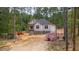 Construction in progress shows the exterior framing, brick foundation, and wood materials at 15 Bourbon St, Fuquay Varina, NC 27526