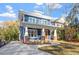 Welcoming two-story home featuring a classic front porch and a neatly landscaped yard with a long driveway at 1608 Scales St, Raleigh, NC 27608