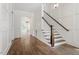 Bright foyer with hardwood floors, white trim, wainscotting and staircase at 1608 Scales St, Raleigh, NC 27608