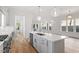 Modern kitchen featuring a spacious island with quartz countertops, stainless steel appliances, and open layout at 1608 Scales St, Raleigh, NC 27608
