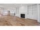 Bright living room featuring hardwood floors, a modern fireplace with built-in bookshelves, and an open floor plan at 1608 Scales St, Raleigh, NC 27608