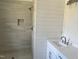 Modern bathroom with a beautifully tiled shower and a vanity featuring a sleek sink and fixtures at 2112 Hamrick Dr, Raleigh, NC 27615