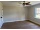 Bright and airy bedroom featuring light hardwood floors, neutral walls, and a ceiling fan for optimal comfort at 2112 Hamrick Dr, Raleigh, NC 27615