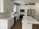 Modern kitchen featuring white cabinets, stainless steel appliances, subway tile backsplash and gorgeous marble countertops at 2112 Hamrick Dr, Raleigh, NC 27615