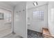 Elegant bathroom featuring a walk-in shower with rock flooring and a bench at 2118 Cloud Cover Ln, Raleigh, NC 27614