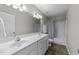 Well-lit bathroom with double sinks, tile floors, and shower-tub combo at 2118 Cloud Cover Ln, Raleigh, NC 27614