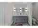 Bathroom featuring a double vanity and modern lighting at 2118 Cloud Cover Ln, Raleigh, NC 27614