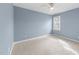 Serene bedroom with soft blue walls, neutral carpet, and natural light at 2118 Cloud Cover Ln, Raleigh, NC 27614
